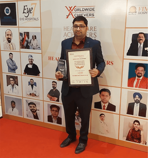 Dr. Nitin Singhal receiving a healthcare achievement award